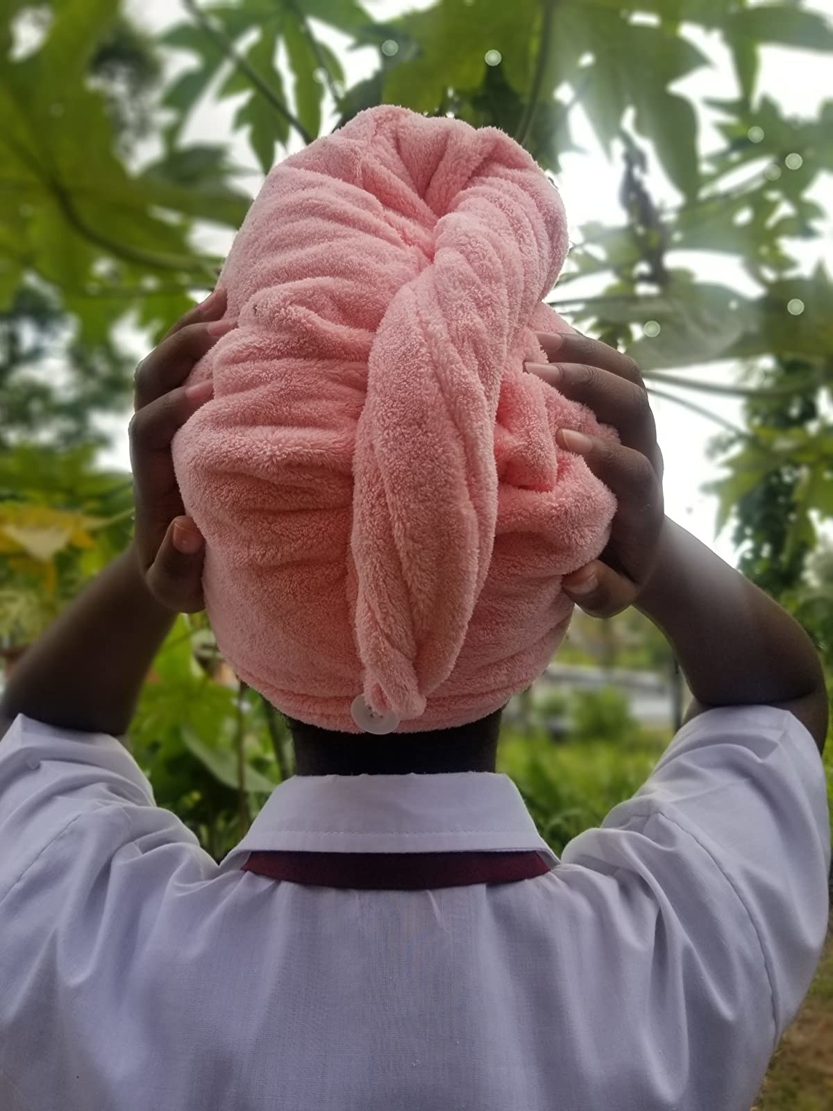 Reviewer wearing the pink anti-frizz microfiber hair towel