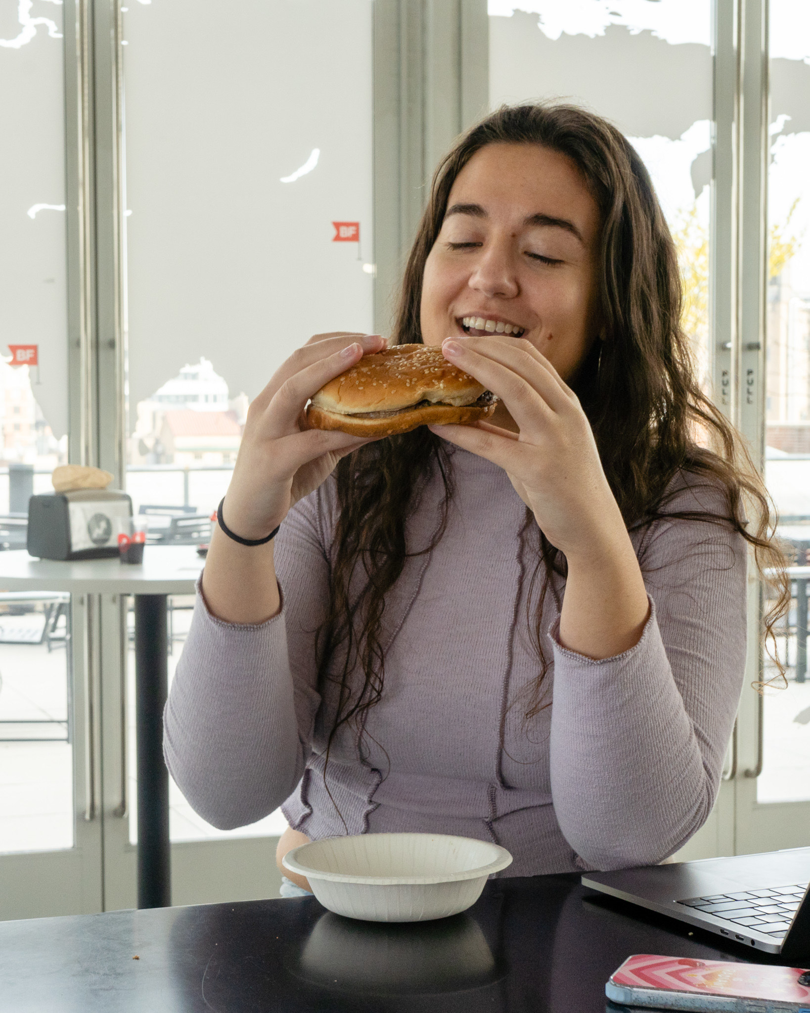 a woman eats a burger