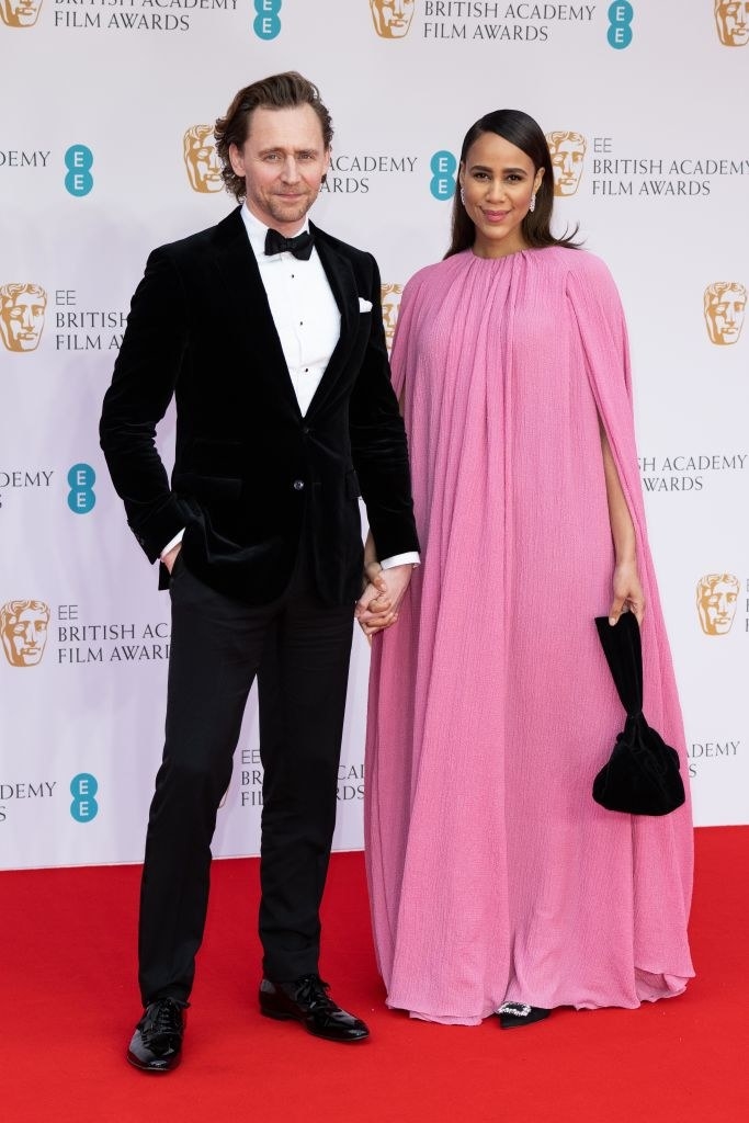 Tom and Zawe sweetly hold hands on the red carpet
