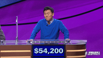 jeopardy winner looking at other contestants and shrugging his shoulders