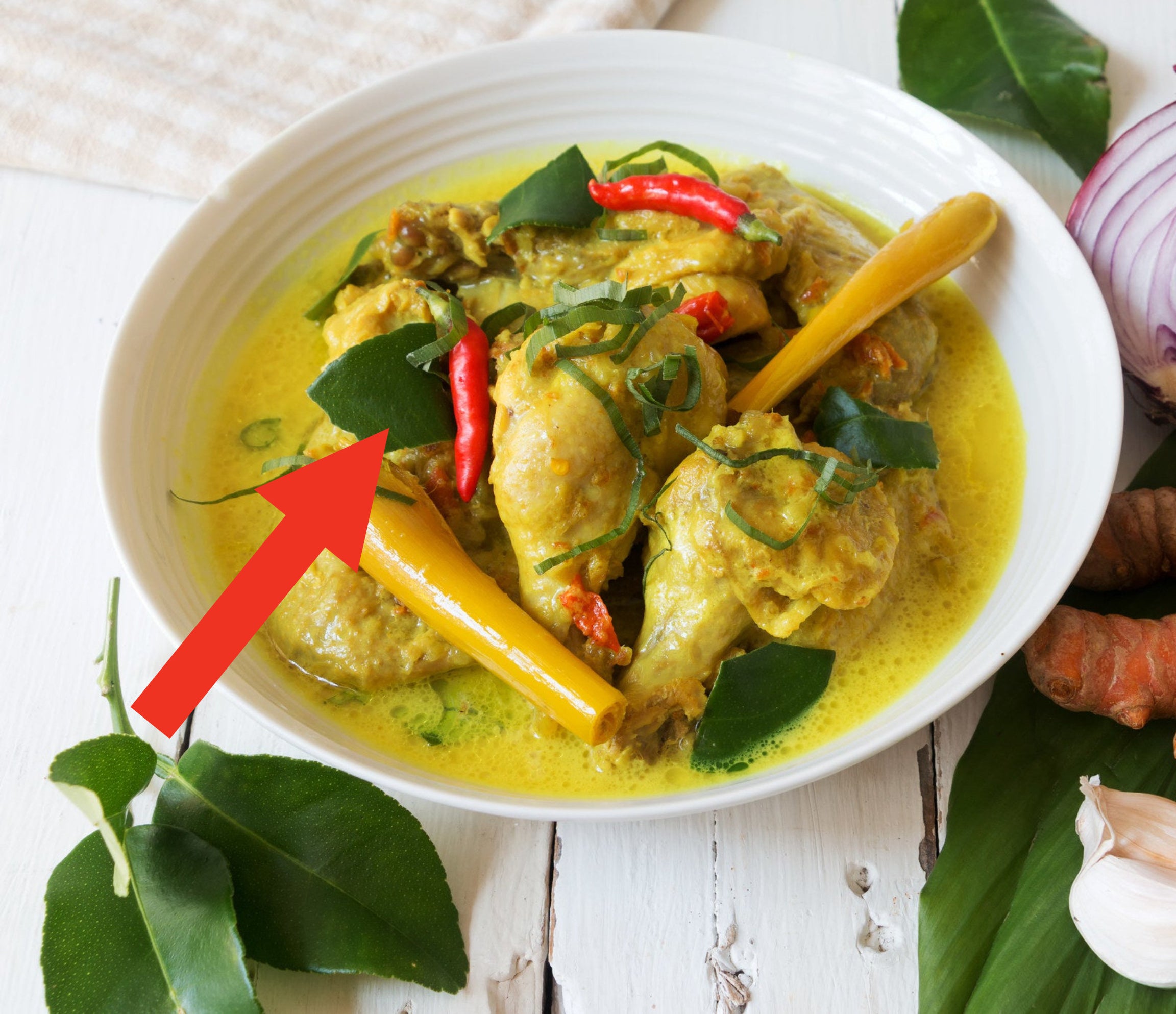 A bowl of curry with kaffir lime leaves