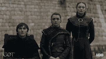 Bran, Arya, and Sansa Stark watching Jon Snow depart on a boat