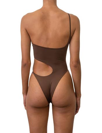 A reviewer wearing the swimsuit in brown