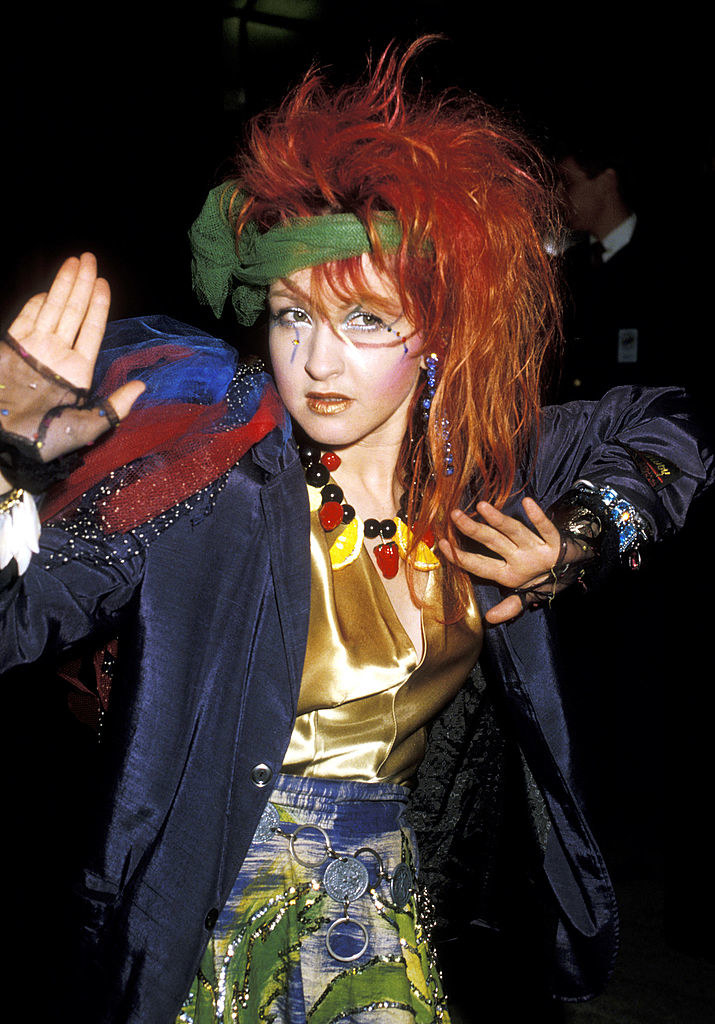Cyndi Lauper sporting bright red hair and colorful clothing at the American Music Awards