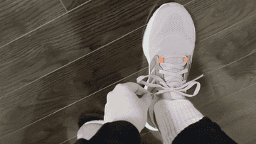 lacing up sneakers
