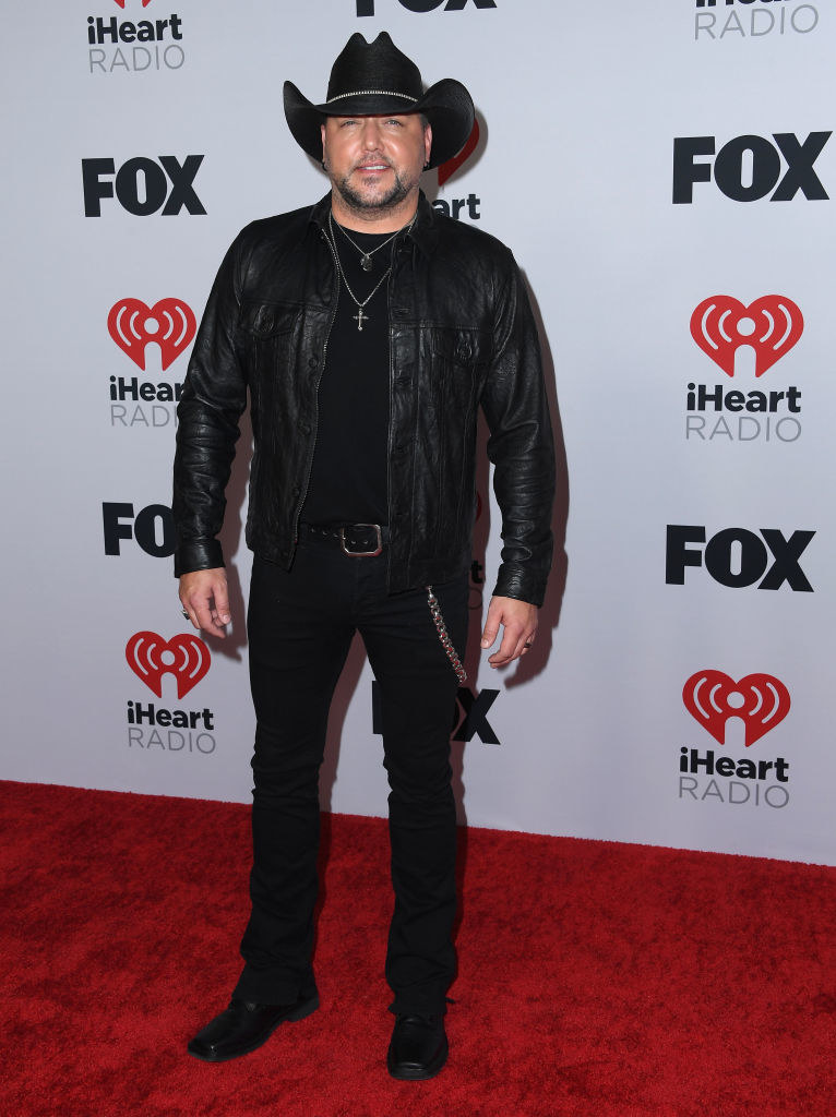 Jason wore a leather jacket, form-fitting pants, and a cowboy hat