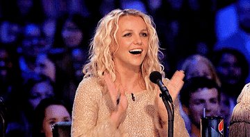 Britney clapping rhythmically and smiling