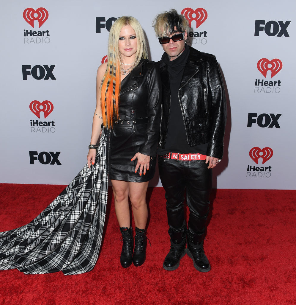 Avril wore a one-shoulder leather dress with an attached tartan-print sash and Mod Sun wore a shirt, leather jacket, and pants with a belt that said Safety on it