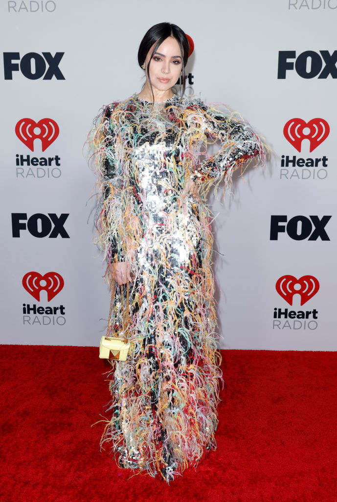Sofia wears a sequin-and-feathered long-sleeved dress