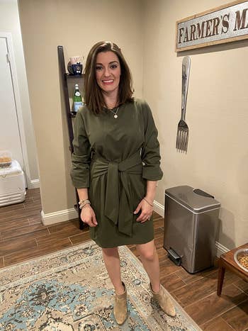 reviewer wearing the green dress in a size small