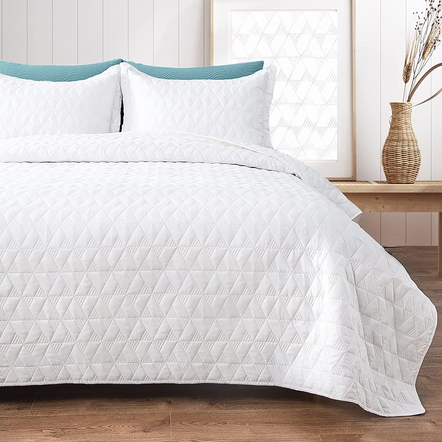 the quilted bedspread on a neatly made-up bed
