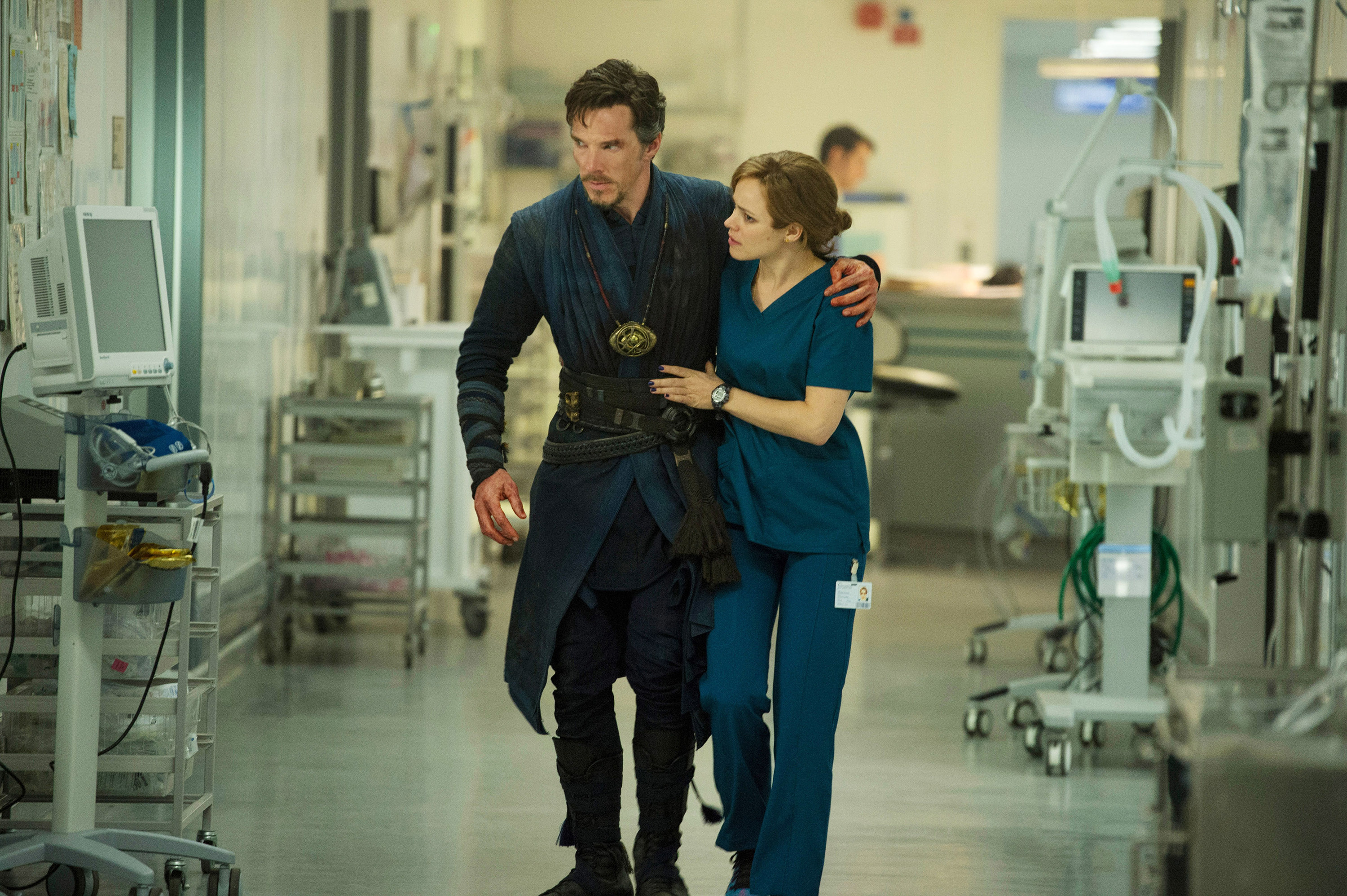 Dr Palmer helps an injured Stephen walk through the hospital