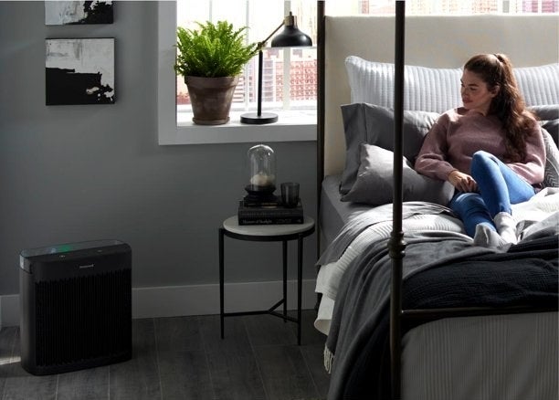 the black air purifier in a room