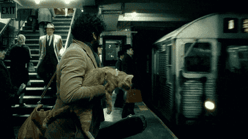 Oscar Isaac as Llewyn Davis catching a subway in Inside Llewyn Davis
