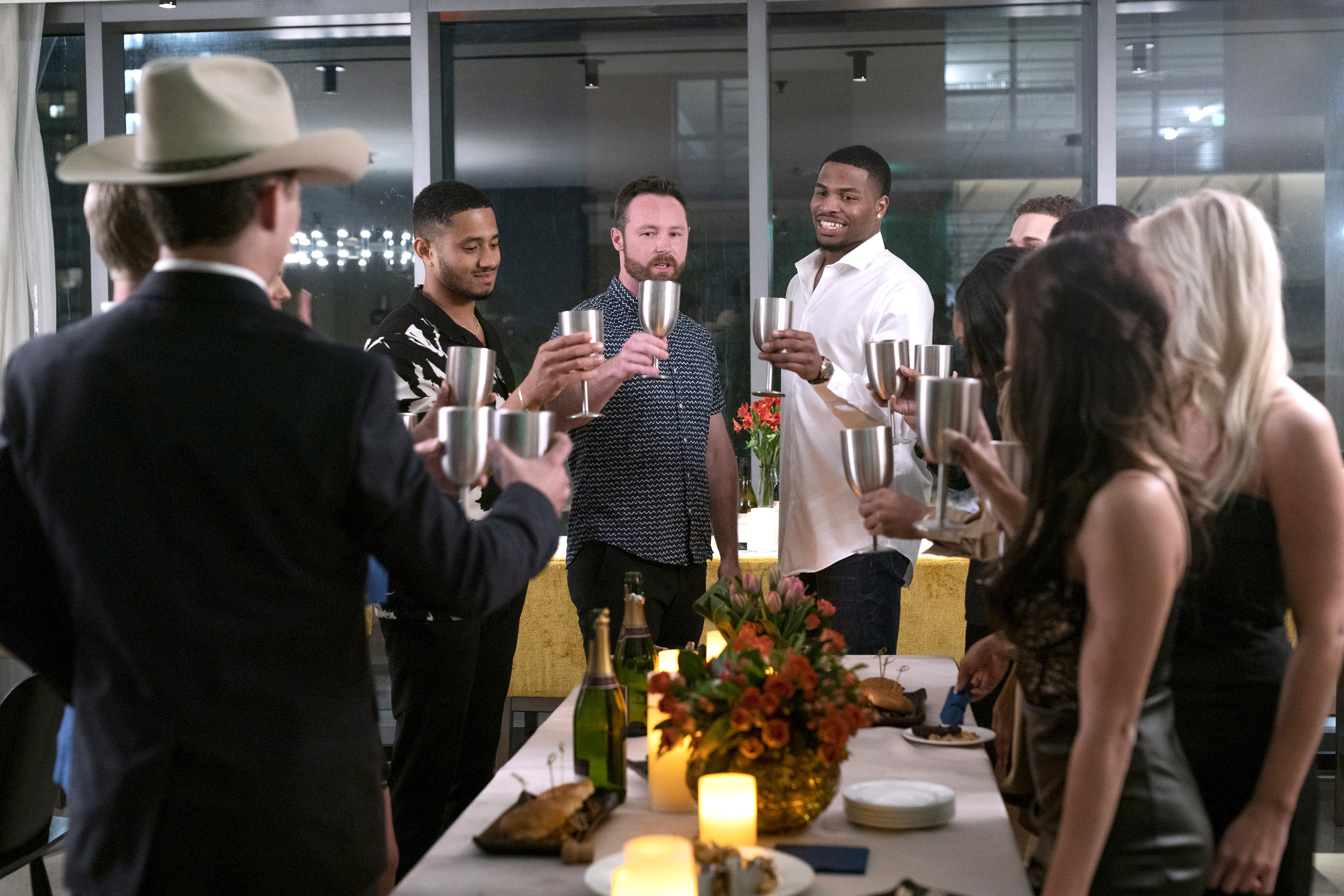 A group of people raising their glasses to make a toast