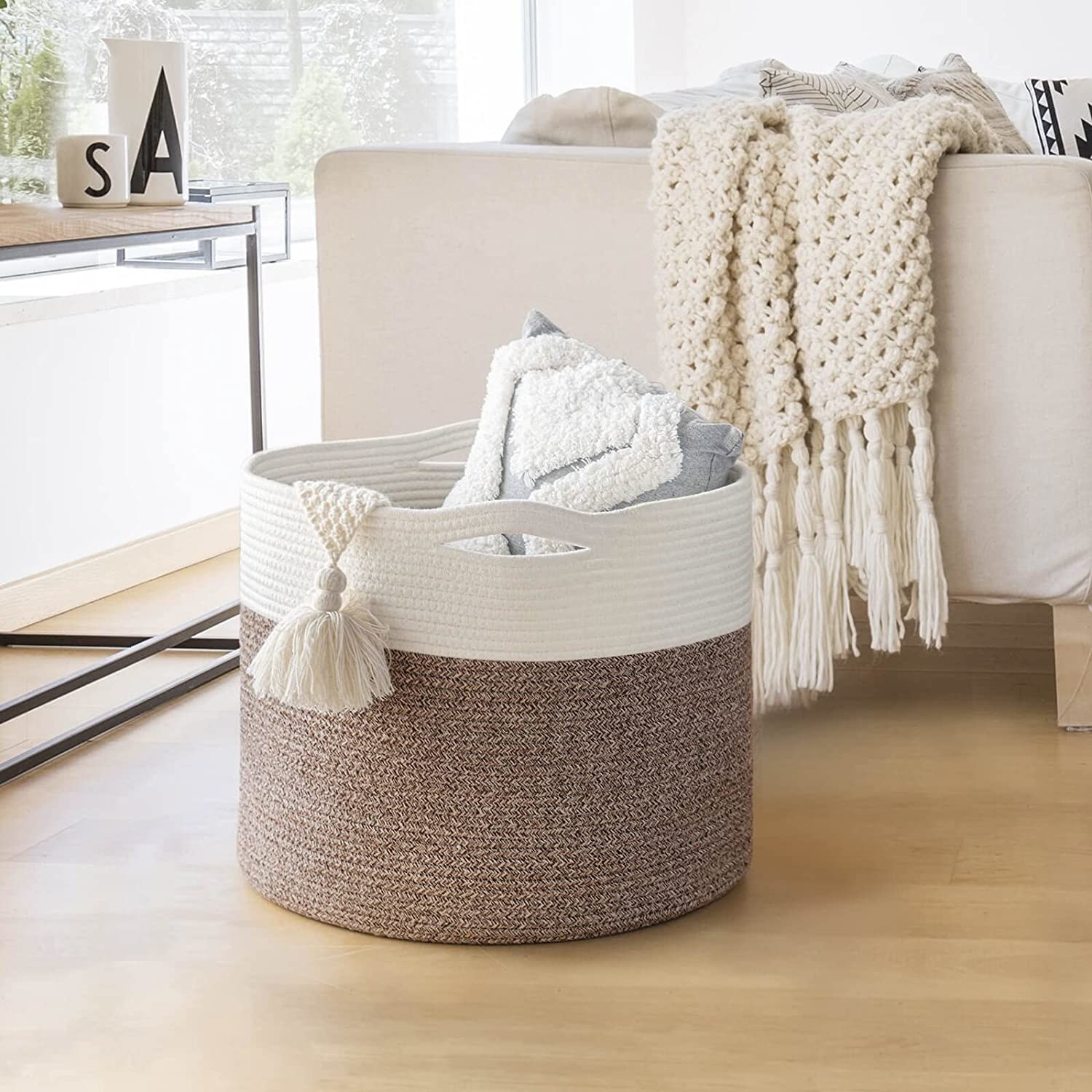 A rope basket holding a blanket in a living room