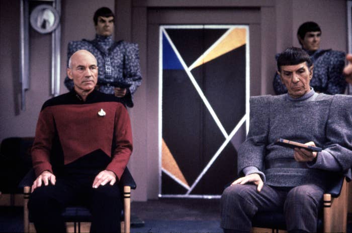 Jean-Luc Picard and Spock sitting next to each other in a scene from Star Trek: The Next Generation
