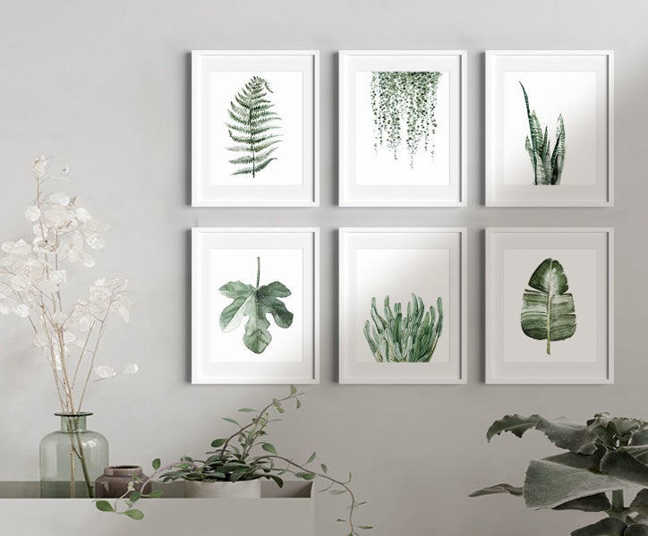 The set of six prints hanging on a wall in a living room