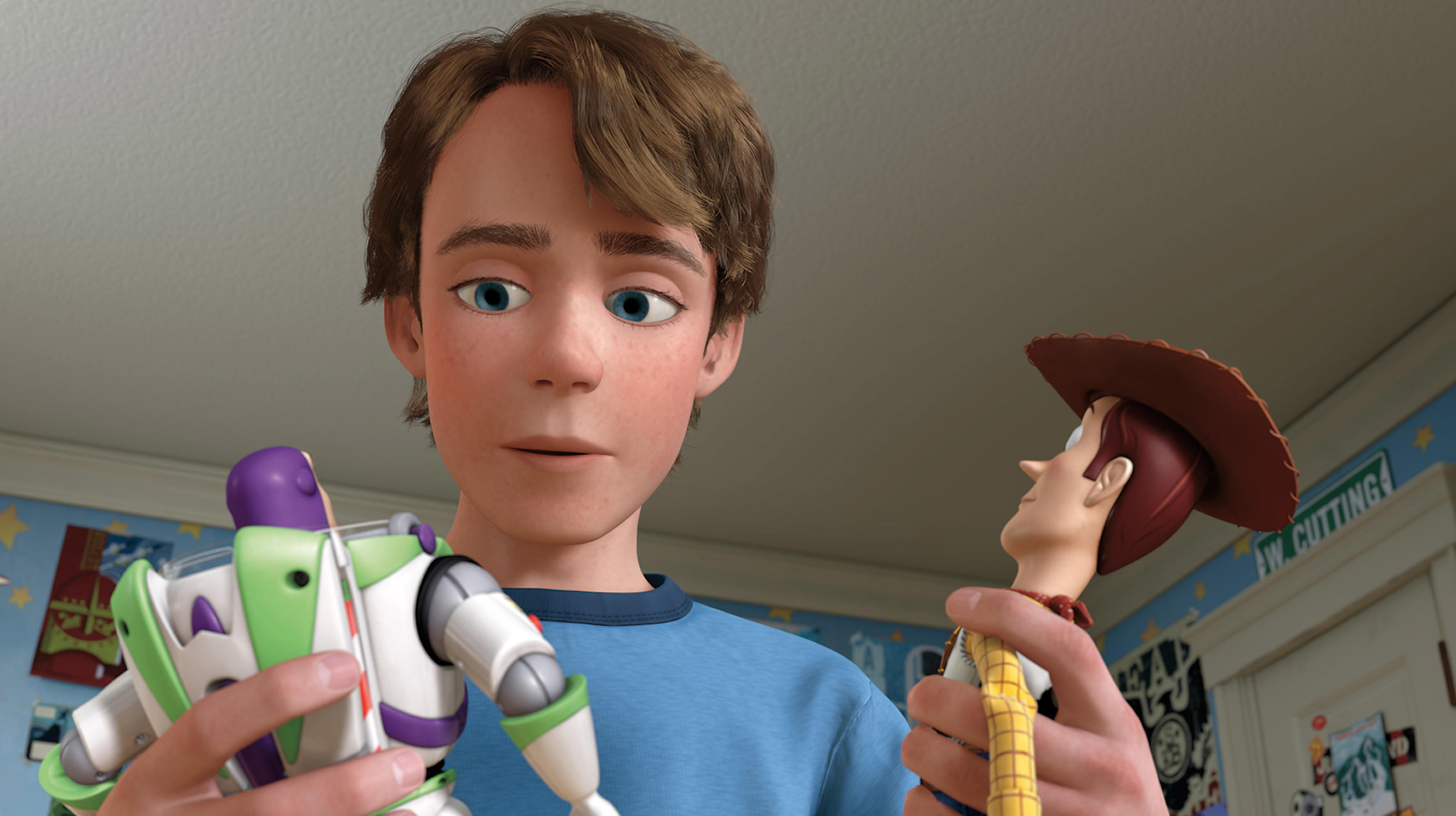 Andy looks at Buzz and Woody