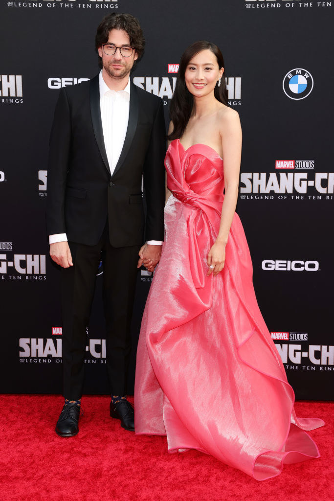 holding hands on the red carpet, Emmanuel wears a trendy suit and egg-printed socks, and Fala wears a beautiful Barbie-approved ballgown with a sweetheart neckline