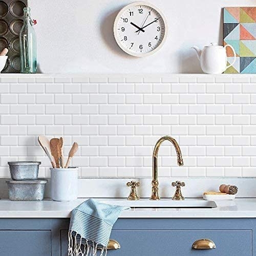 The tile backsplash in a kitchen behind a sink