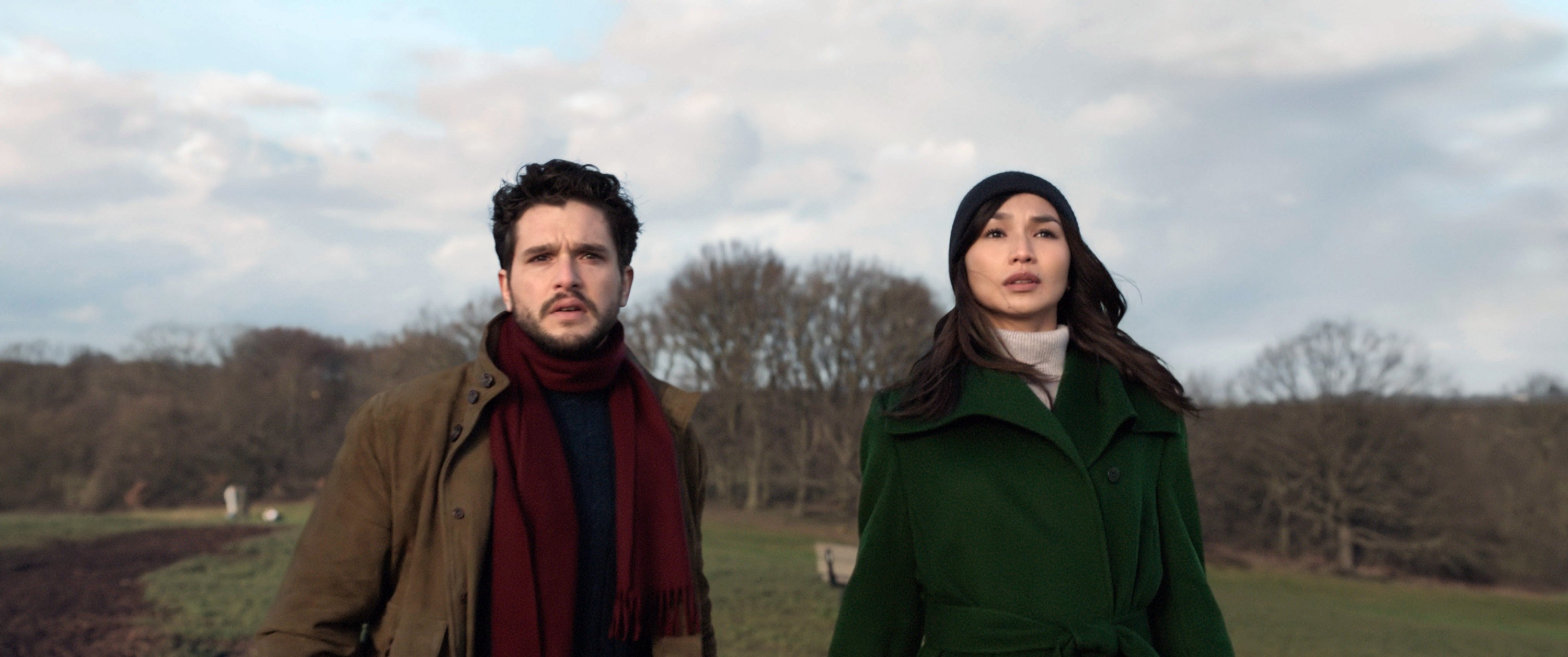 dressed in winter coats, Sersi and Dane gaze into the sky with concern on their faces