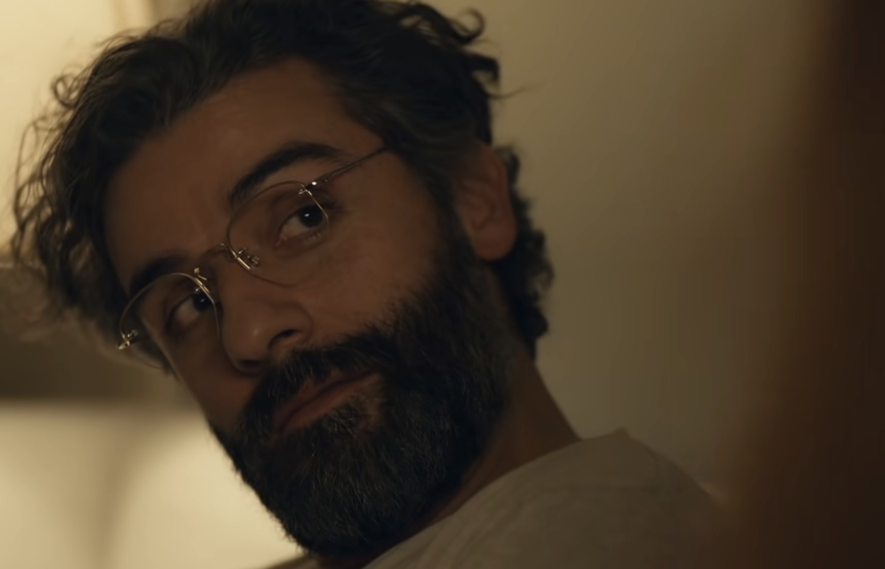 Oscar Isaac with longish hair and glasses in Scenes From a Marriage