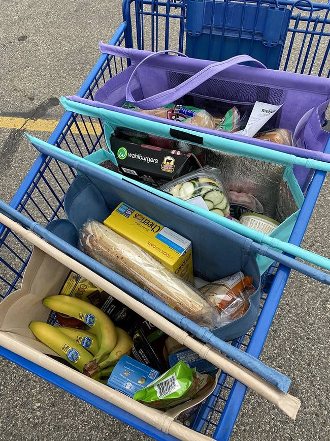 reviewer photo of the four bags holding groceries in a shopping cart