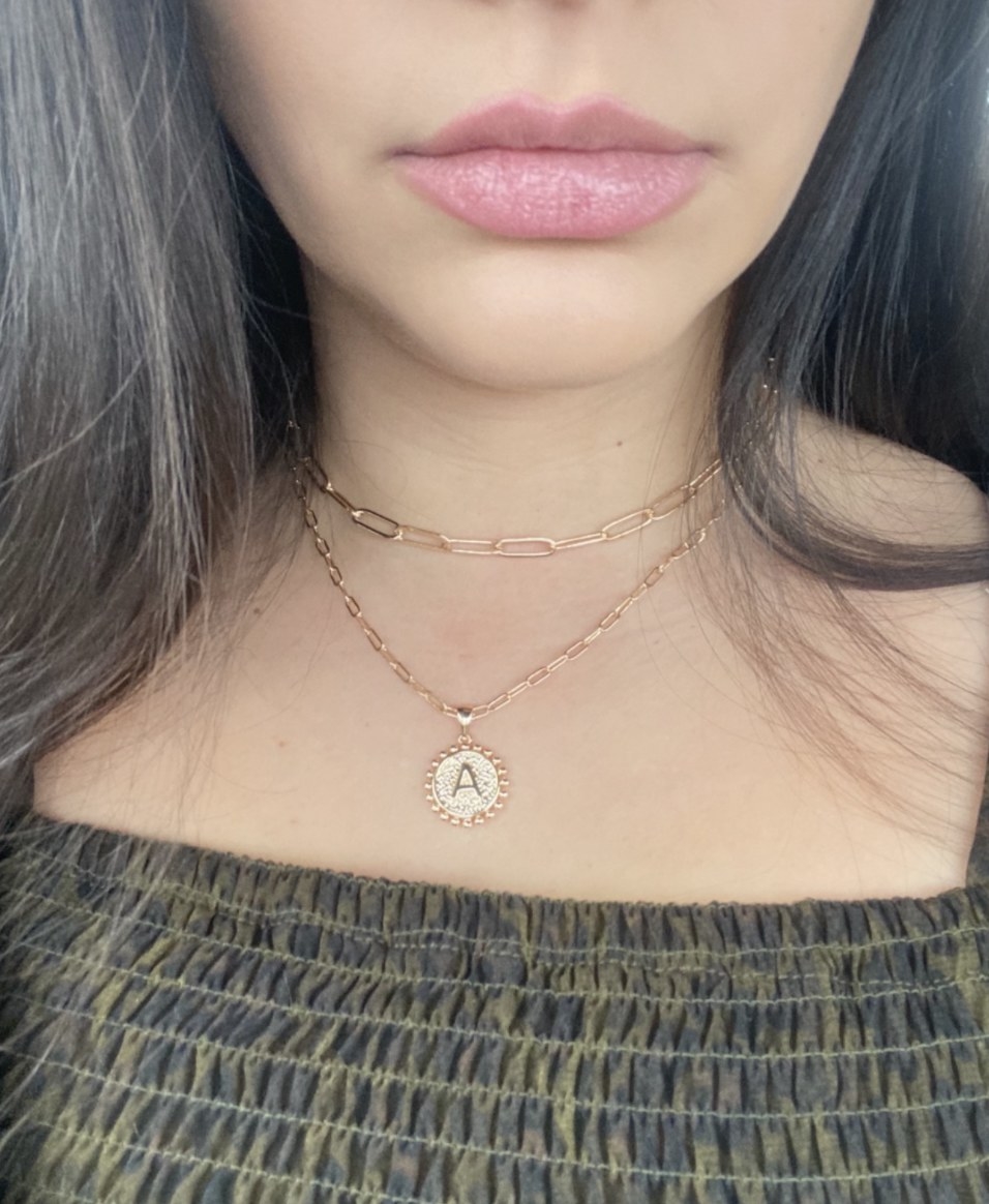 Reviewer wearing the &quot;A&#x27; pendant necklace with gold layering chain