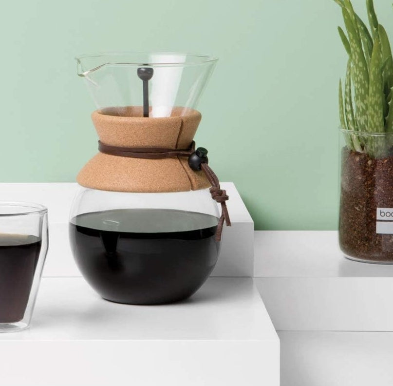 a glass pour over coffee maker with a cord sleeve