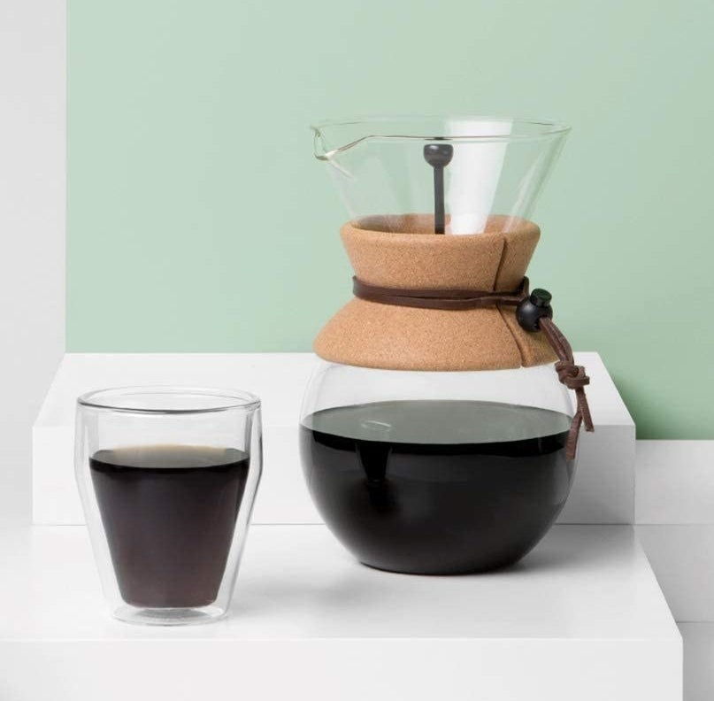a glass pour over coffee maker with a cord sleeve