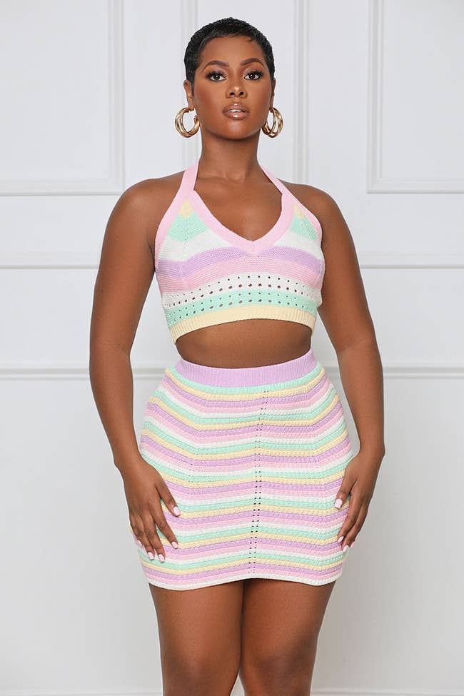 a model in a halter tank and skirt with pastel colors across it