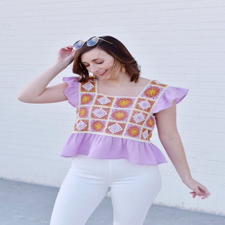 front view of a model in the lilac peplum top