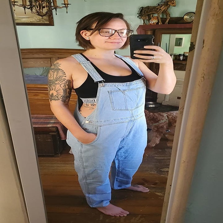 a different reviewer wearing light-wash overalls
