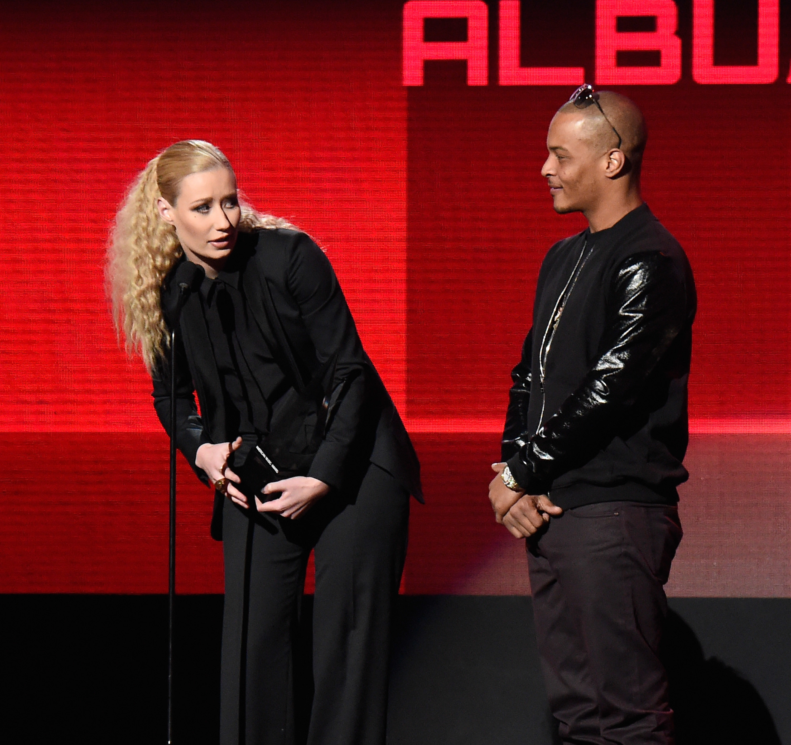 Iggy Azalea and T.i. accept award onstage at the 2014 American Music Awards