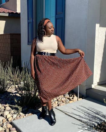reviewer wearing the skirt in the coffee color