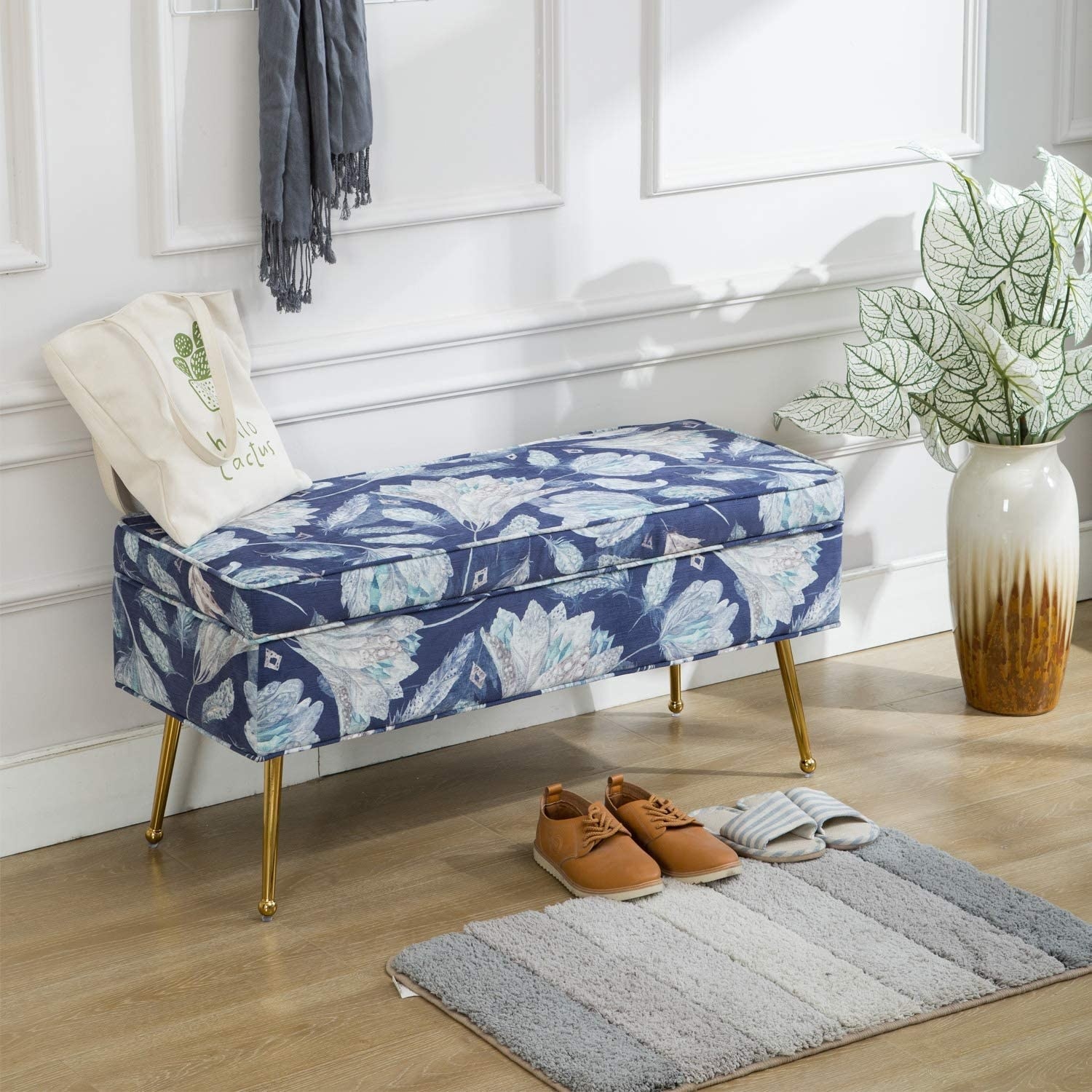 a blue floral bench with gold legs