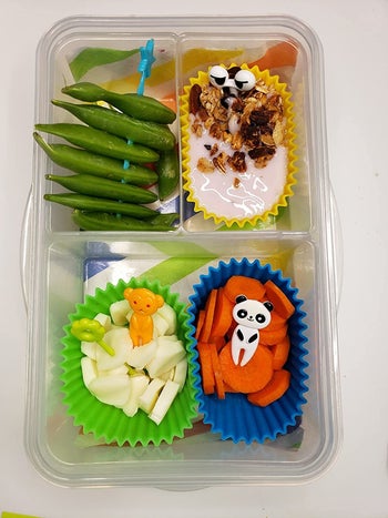 Reviewer's photo showing the animal-shaped food picks in a lunchbox