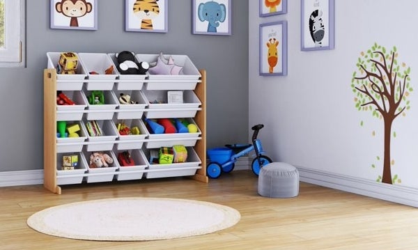 Toy organizer with multiple bins in a child&#x27;s room, surrounded by wall art and a toy scooter