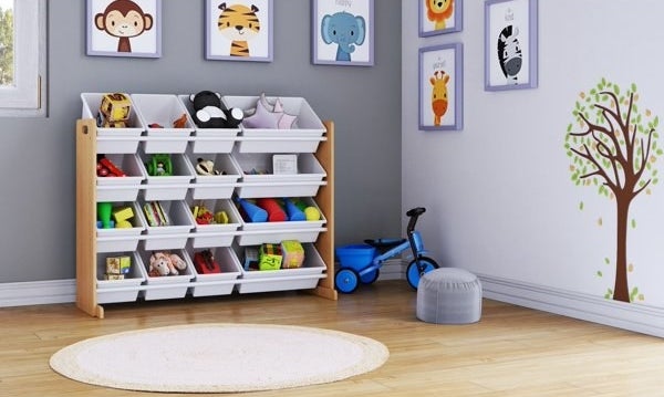 Toy organizer with multiple bins in a child&#x27;s room, surrounded by wall art and a toy scooter