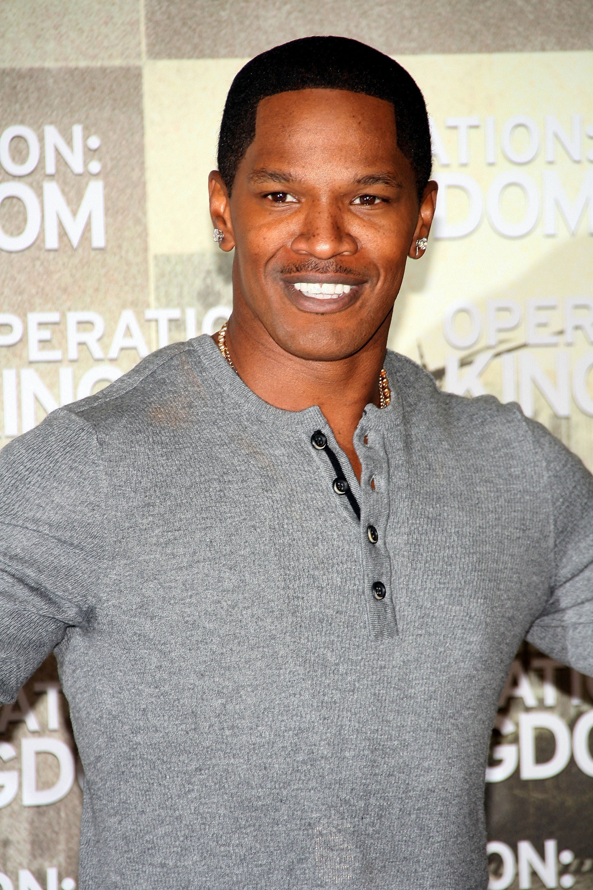 Jamie Foxx smikes at a Hollywood red carpet event
