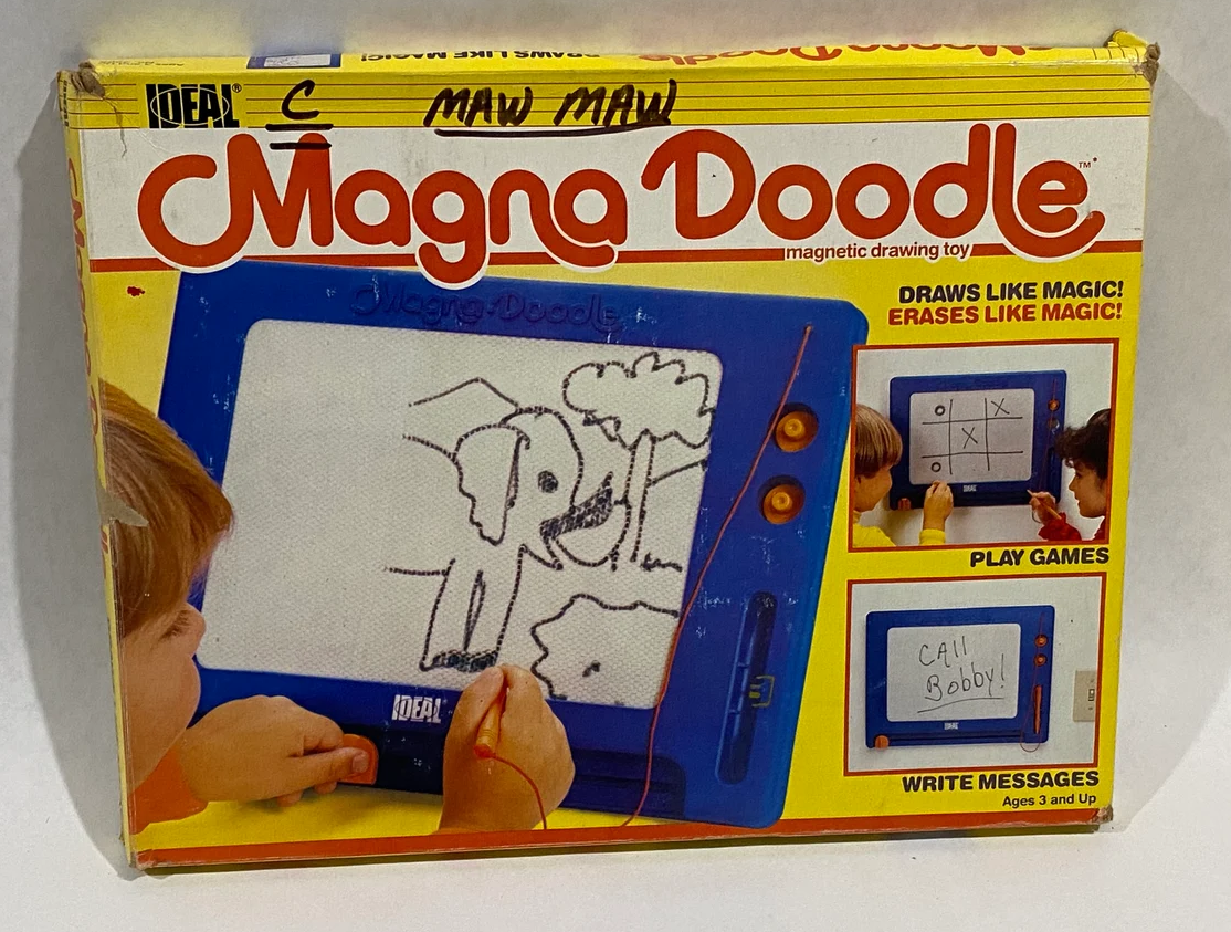 Magna Doodle box with kid drawing an elephant on the cover of it