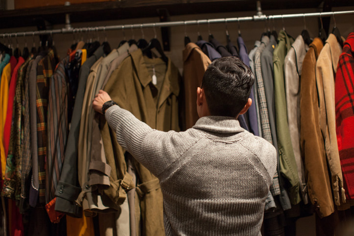 Person looking through clothes at thrift shop