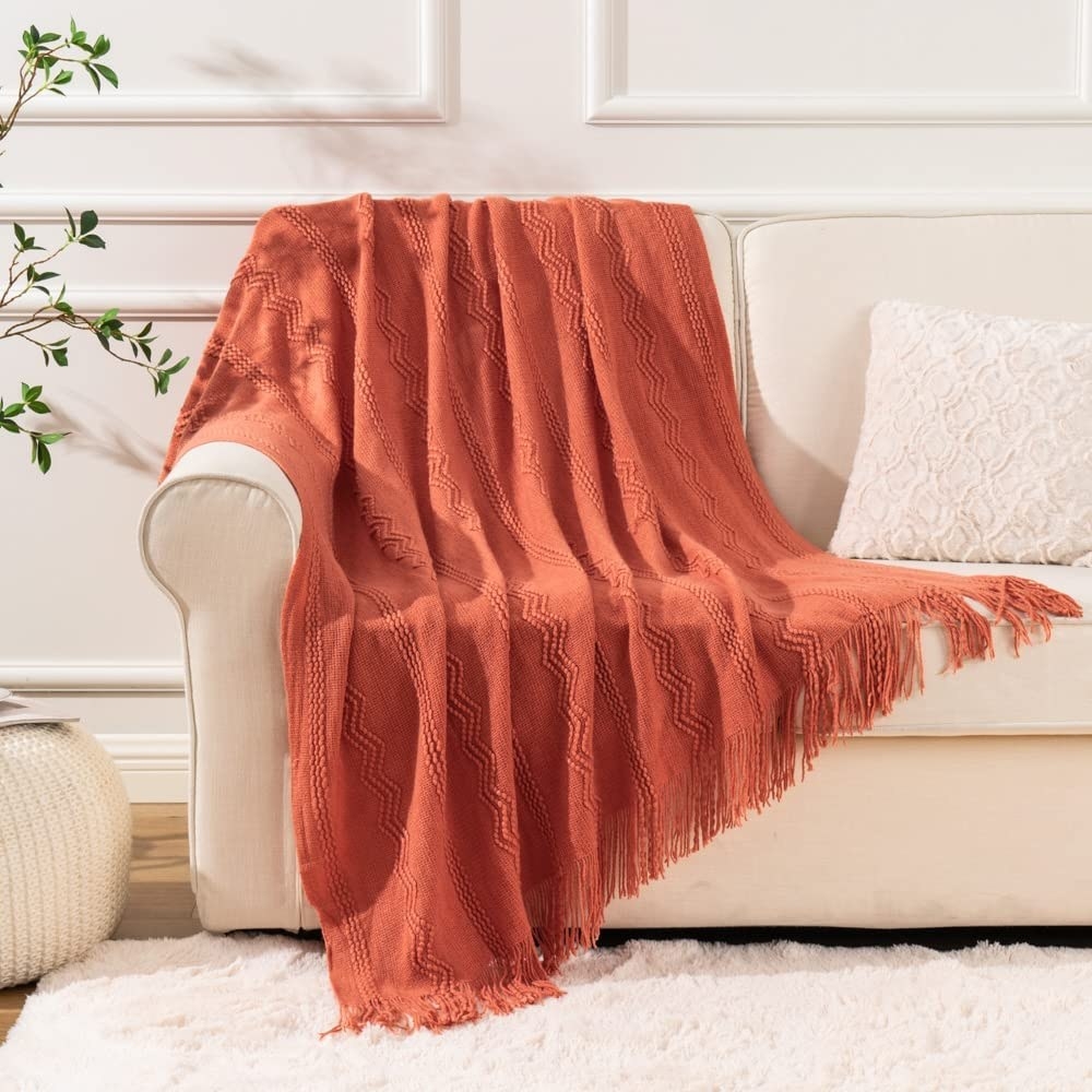 The throw blanket laying over a couch in a living room