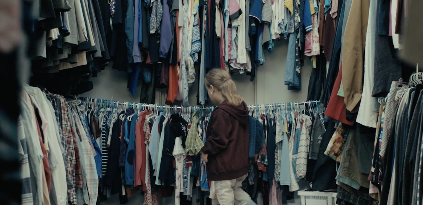 Julka looking at clothes in a store in the film