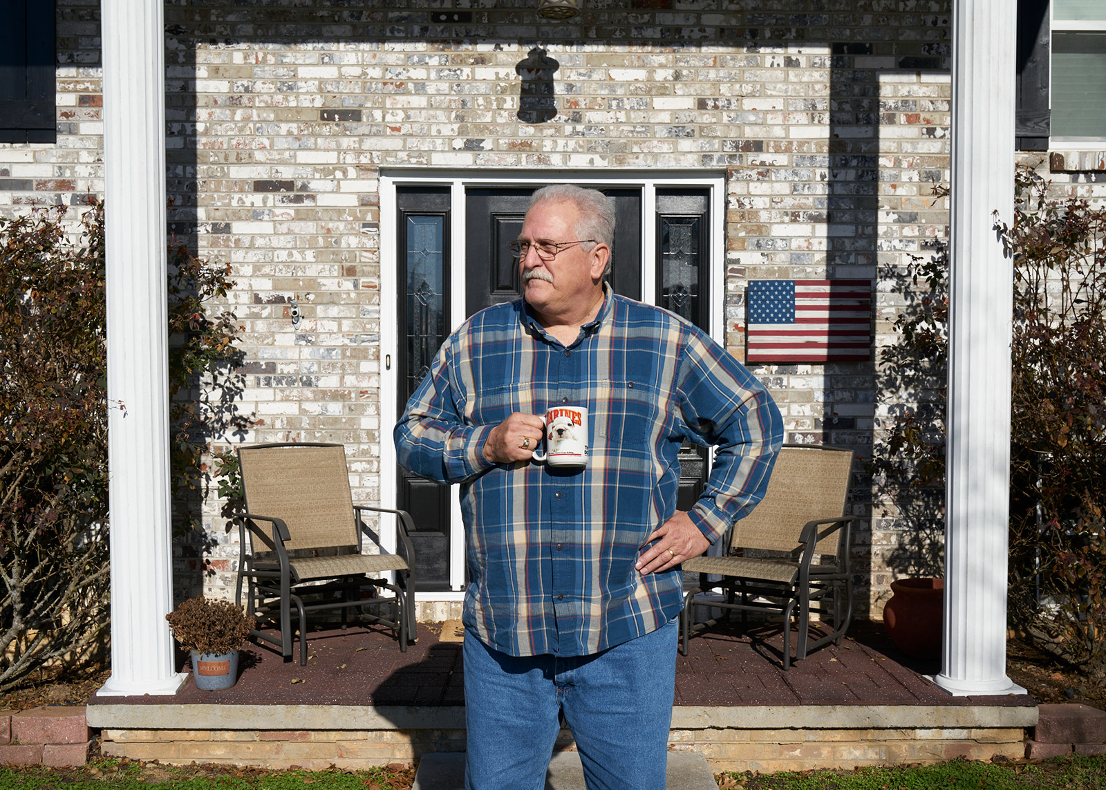 Tim Lamey stands in front of his house