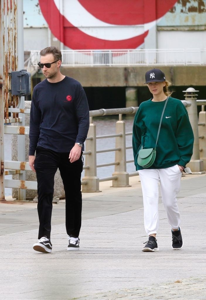 both wearing long-sleeved shirts and sweatpants, Jennifer and Cooke go for a walk together