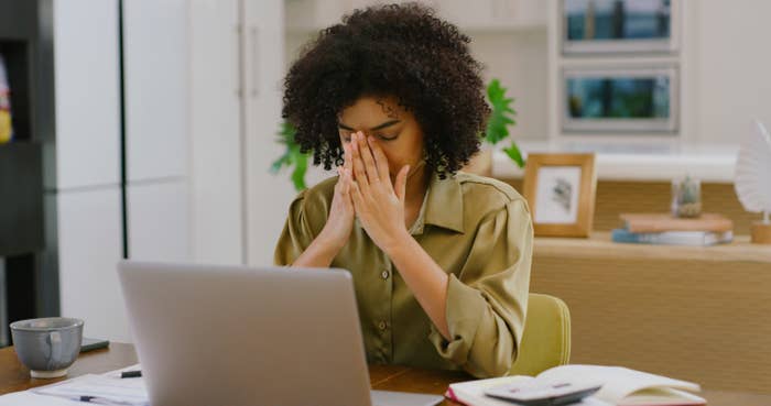 Woman looking stressed while working on computer