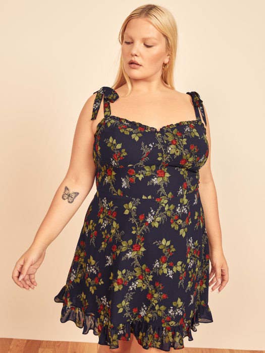 Model wearing the navy and floral printed dress