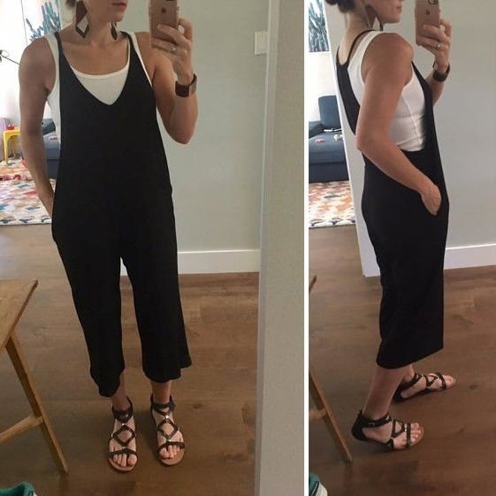 reviewer wearing the jumpsuit in black with white tank underneath